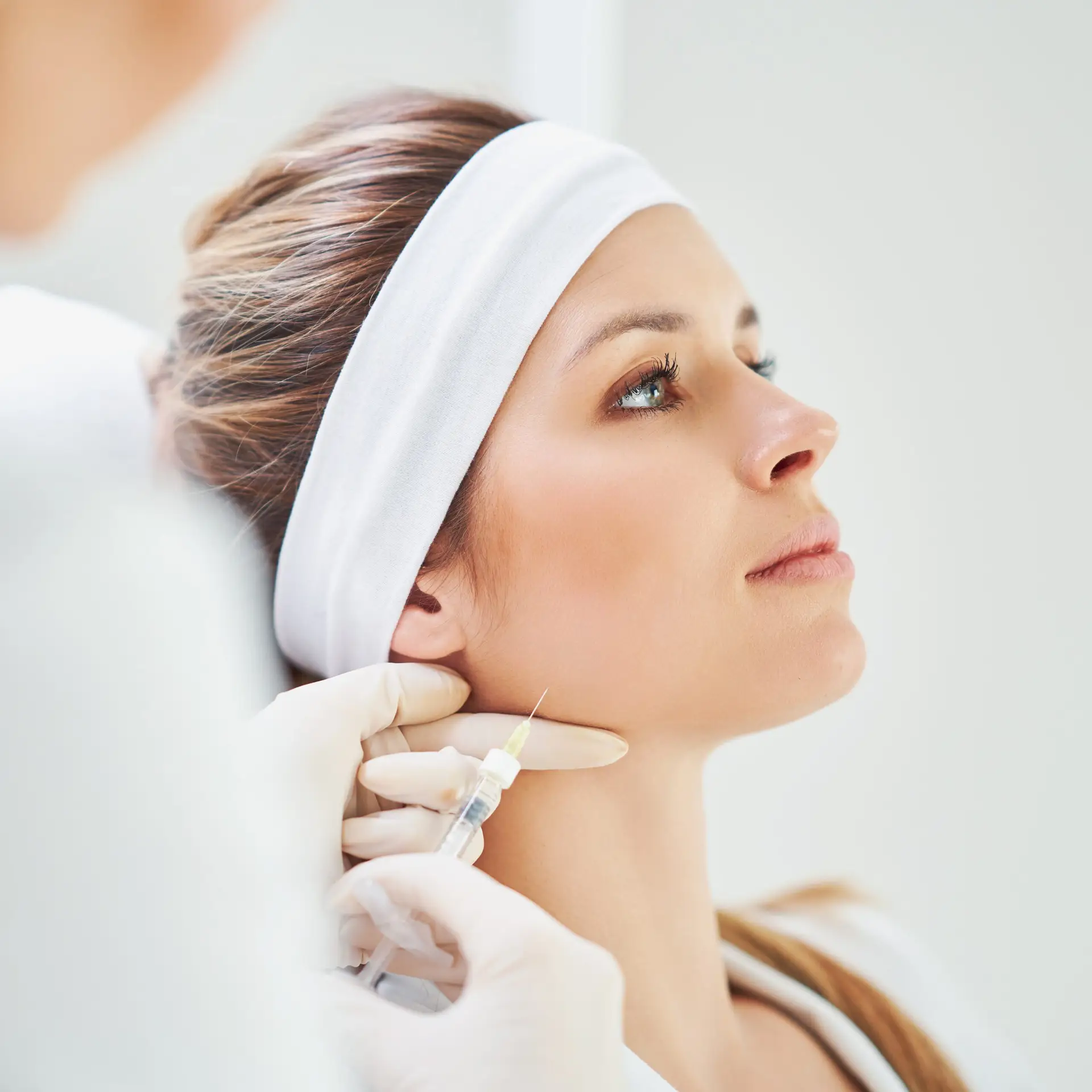 Patient receiving cosmetic facial injection treatment